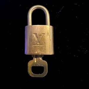 307 Louis Vuitton lock and key, has wear and is numbered 307.